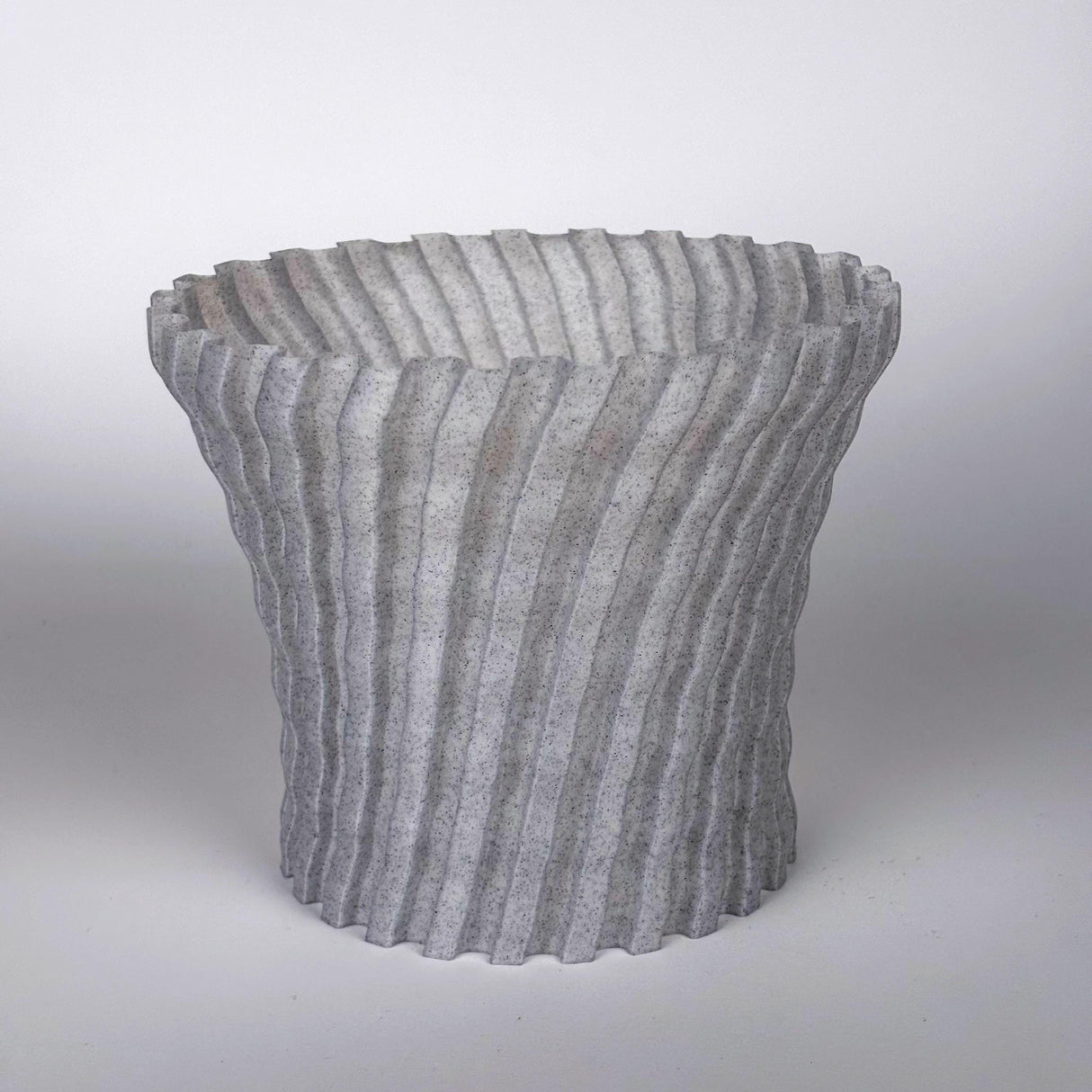 Modern zig zag 3D printed planter cover in grey, adding sleek style to indoor plant decor.