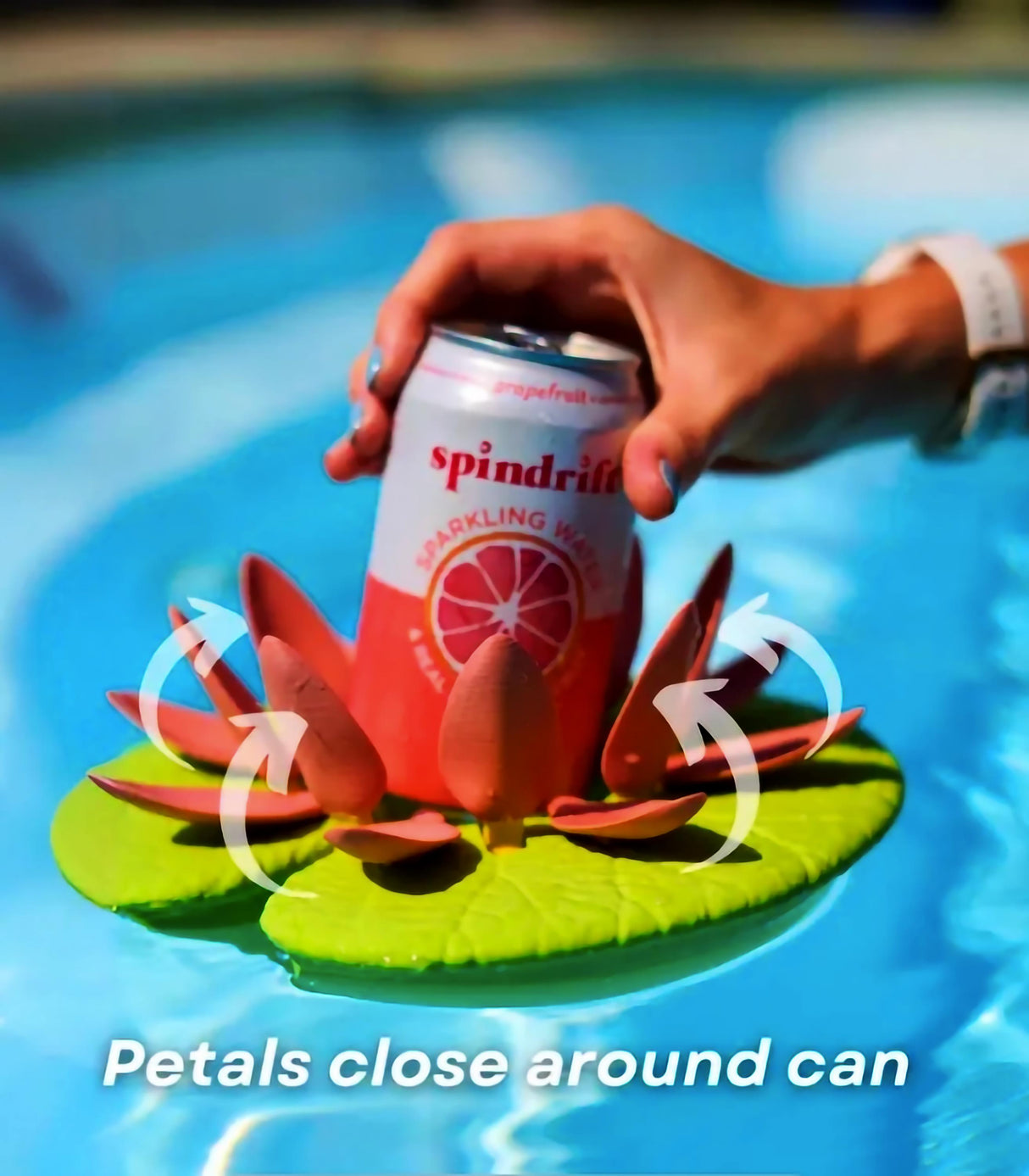 Floating lily pad cupholder stabilizing a drink can in a pool, featuring self-adjusting petals for secure hold.