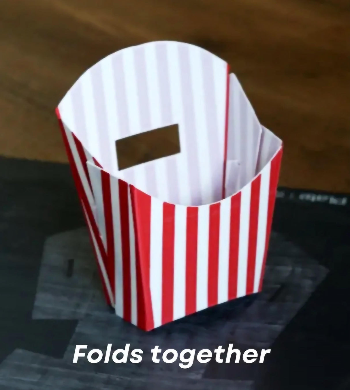 Origami-style red and white striped container folds together, ideal for fun snack presentation.