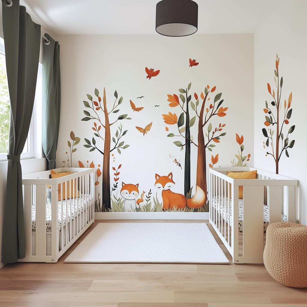 Woodland nursery with forest fox wall decal, trees, butterflies, and cribs in warm autumn colors.