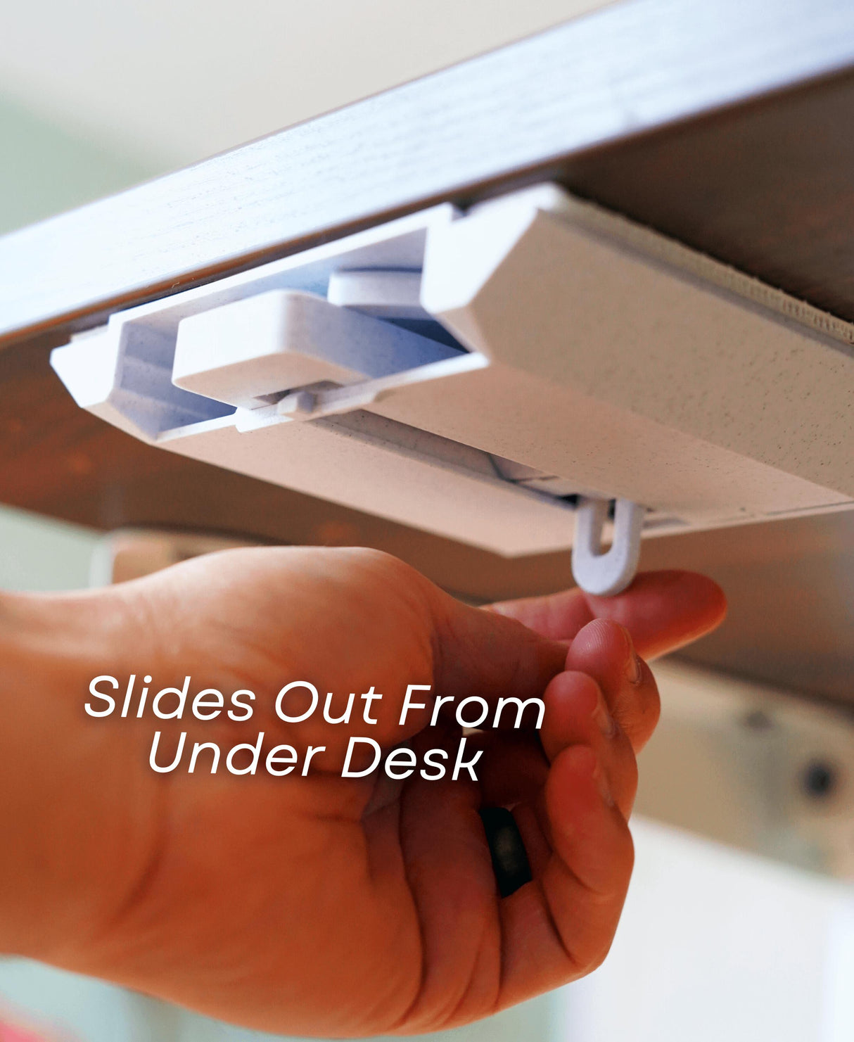 Retractable cup holder sliding out from under desk for easy access, showcasing minimalist design.