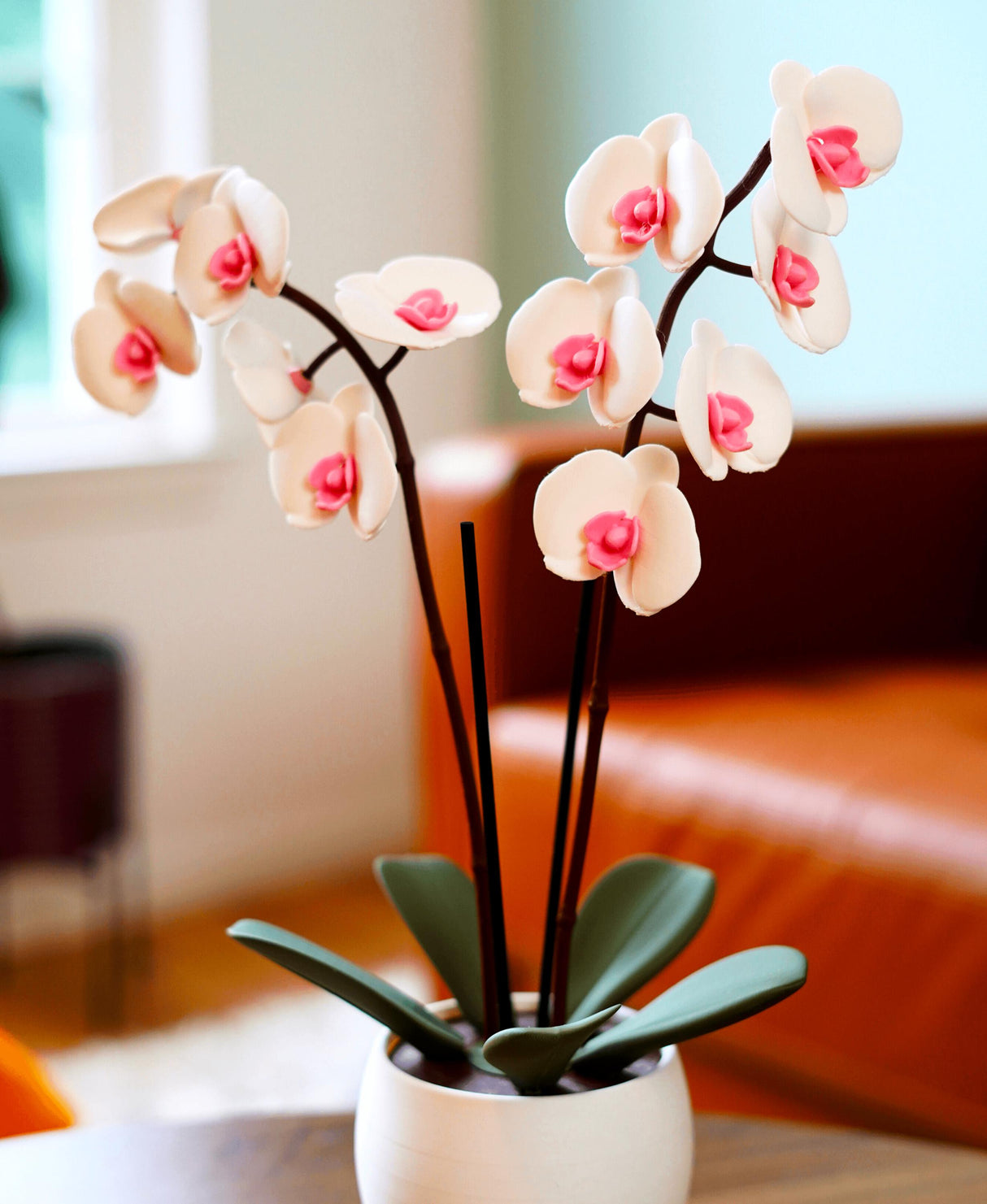 Elegant 3D printed orchid oil diffuser and incense holder with pink flowers and green leaves, perfect home decor.