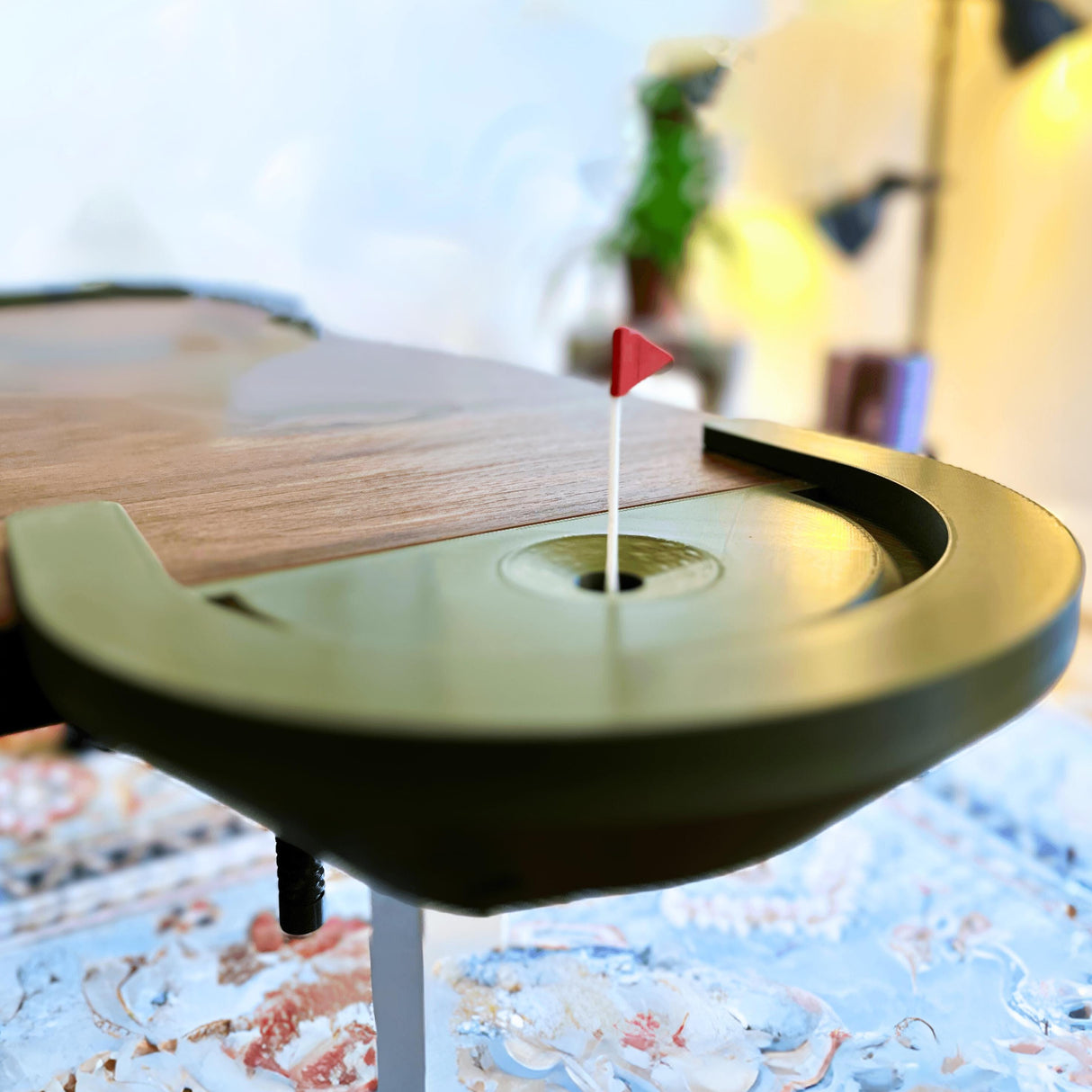 Close-up of a mini golf putting green with a red flag, ideal for desk play and gifts for golf lovers.