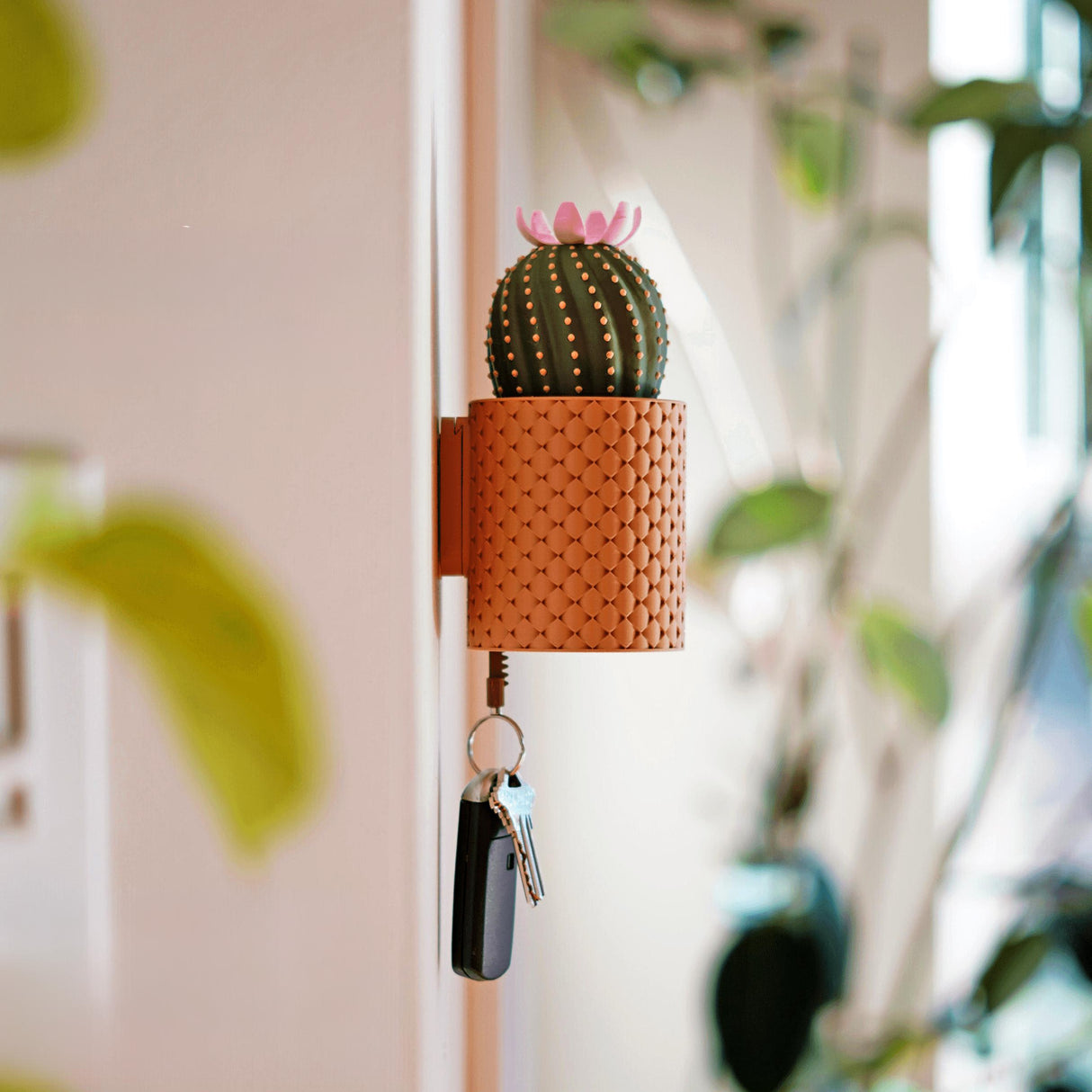 Blooming wall key holder with cactus design, featuring keys hanging from a decorative pot for functional home decor.