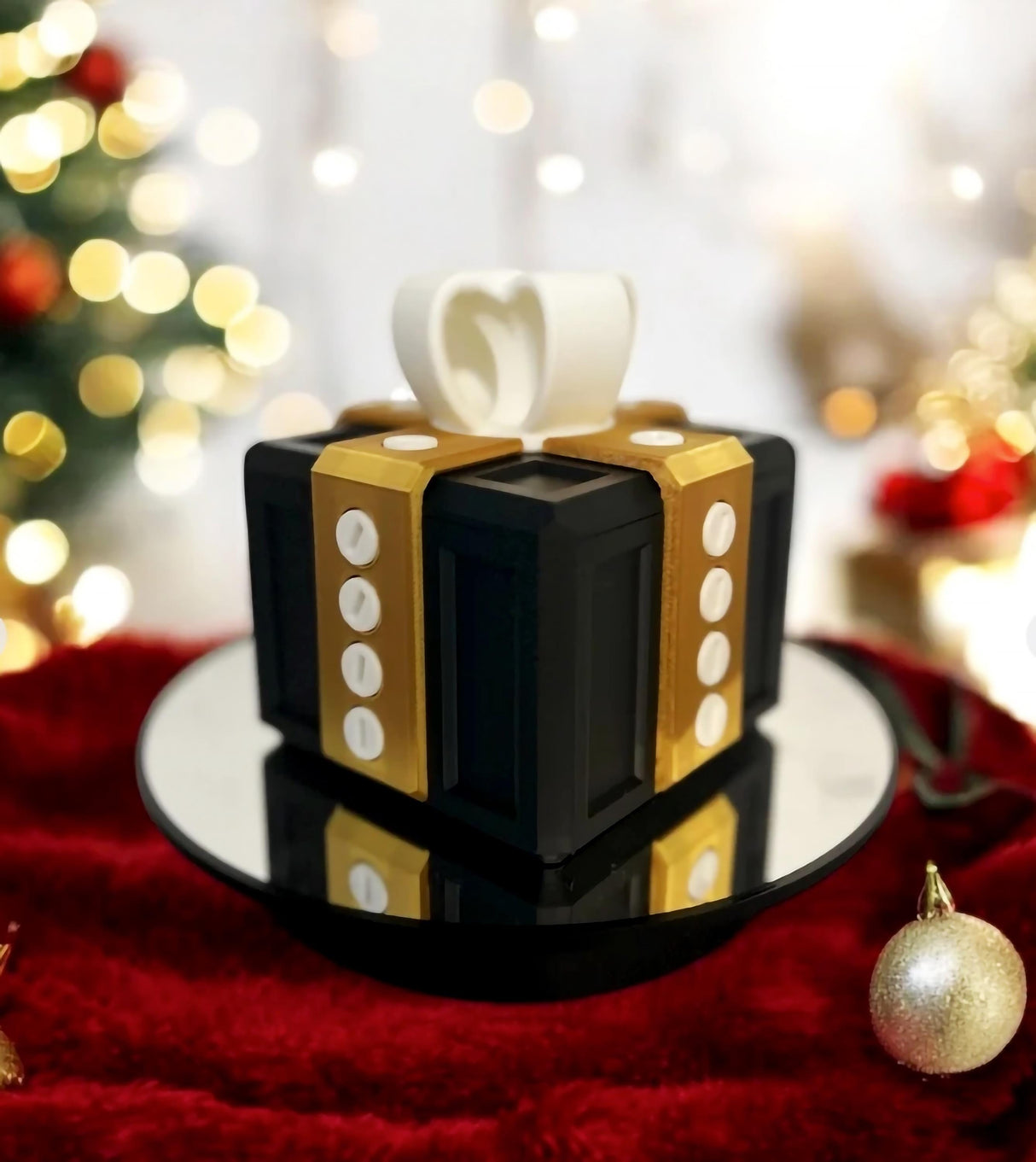 Mini Annoying Gift Box with gold ribbon on a reflective surface, perfect for prank gifts and fun challenges.