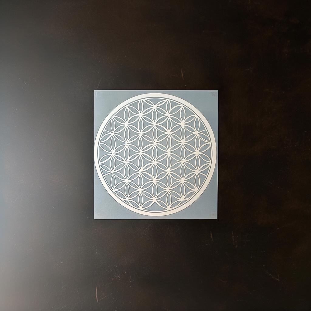 Flower of Life stencil on a blue background, showcasing intricate sacred geometry design for DIY home decor projects.