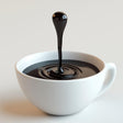 3D printed coffee drop sculpture illusion above a white cup of coffee, perfect for coffee lovers and modern decor.