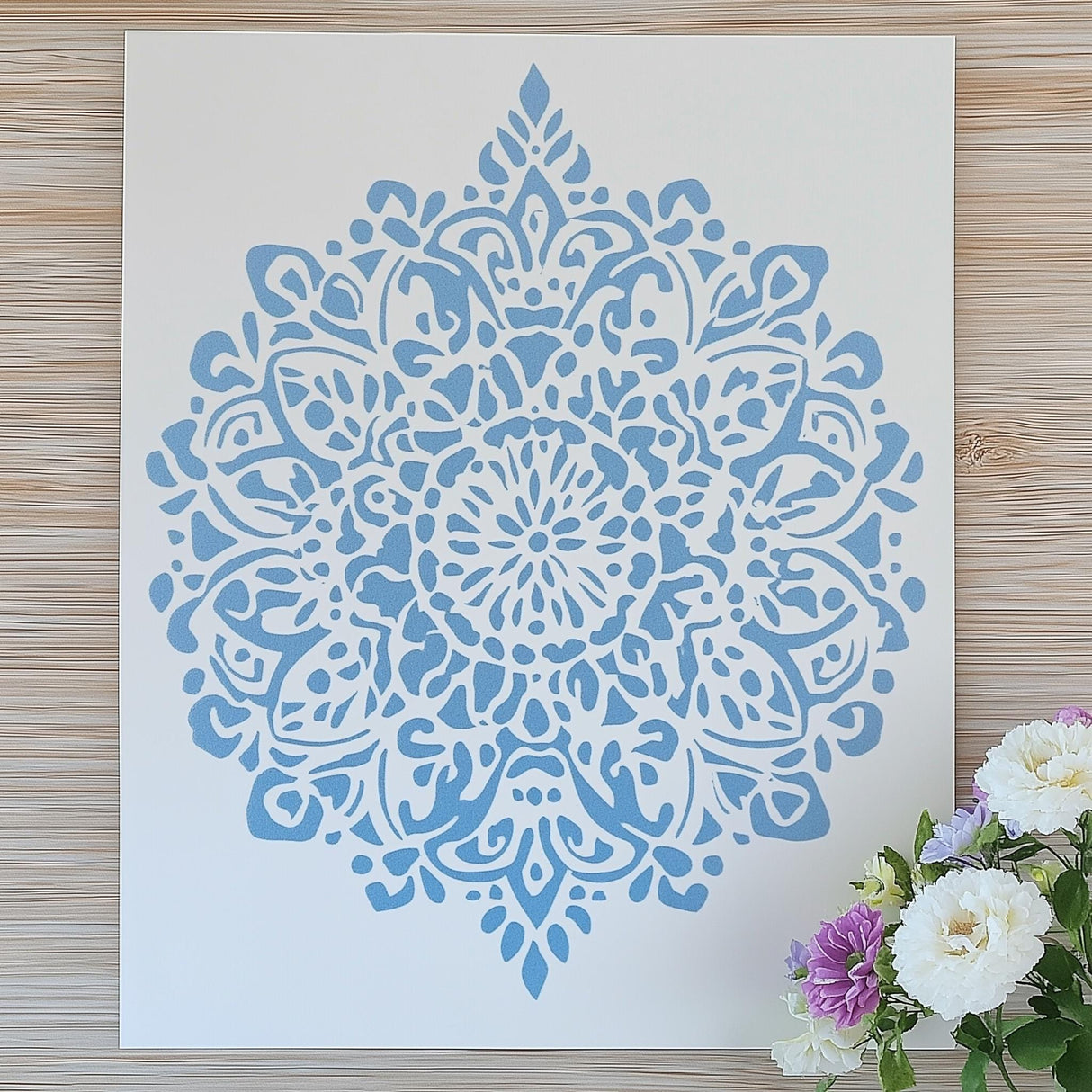 3D-printed mandala stencil in light blue, perfect for DIY wall decor and scrapbooking projects.
