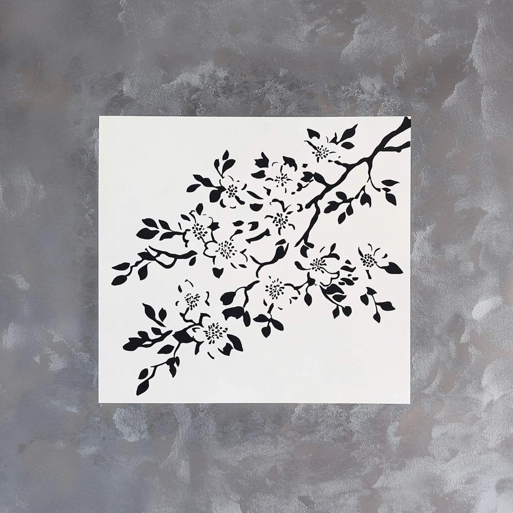 Cherry blossom stencil design featuring intricate branches and flowers on a light background, perfect for DIY crafts.
