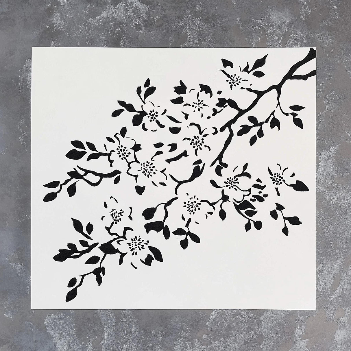Cherry blossom stencil design featuring intricate floral branches and leaves on a white background.