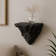 3D printed black rock wall shelf displaying a vase with dried flowers, minimalist home decor accent.