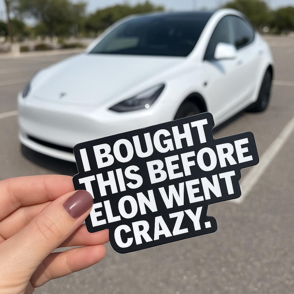 Tesla bumper sticker saying 'I Bought This Before Elon Went Crazy' held in front of a Tesla vehicle.