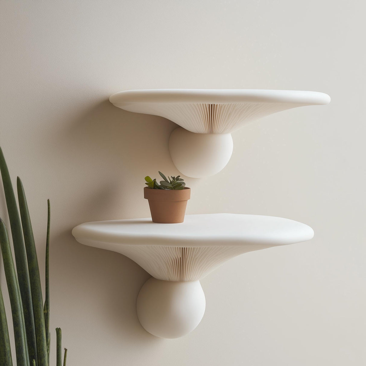 "Set of two matte white 3D printed wall shelves inspired by honey mushrooms, styled with a small terracotta plant pot and minimalist decor."