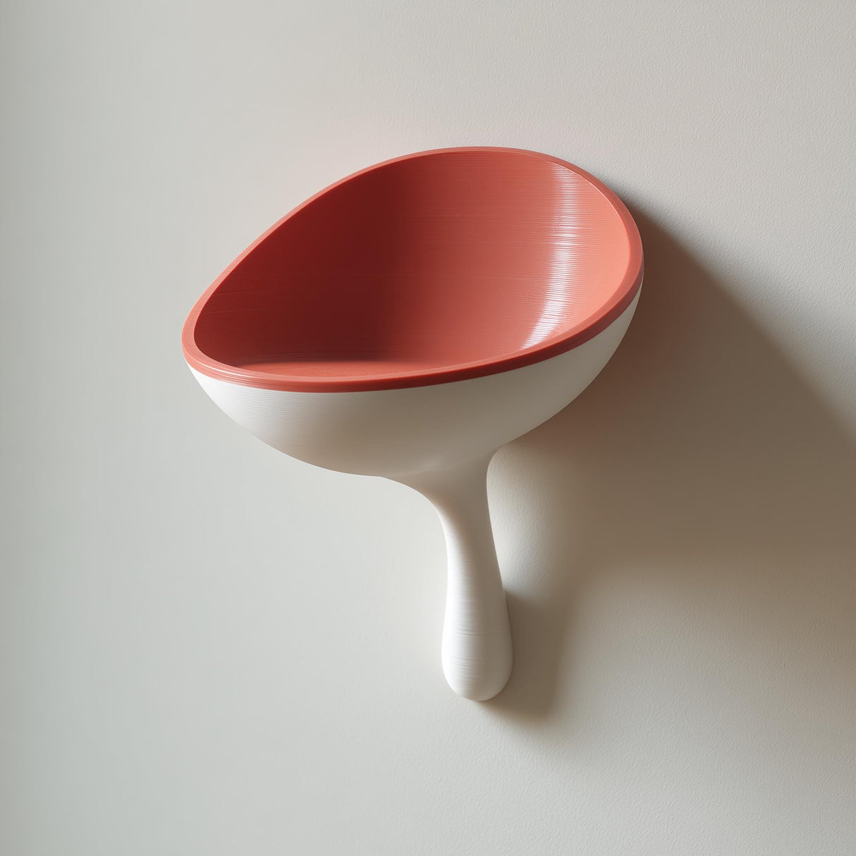 3D printed scoop-shaped wall shelf with a rounded stem support, used as a modern catchall bowl for small items on a light-colored wall.
