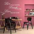 Elegant vinyl decal with inspiring quote 'Live Laugh Love' on a pink wall in a modern dining area.