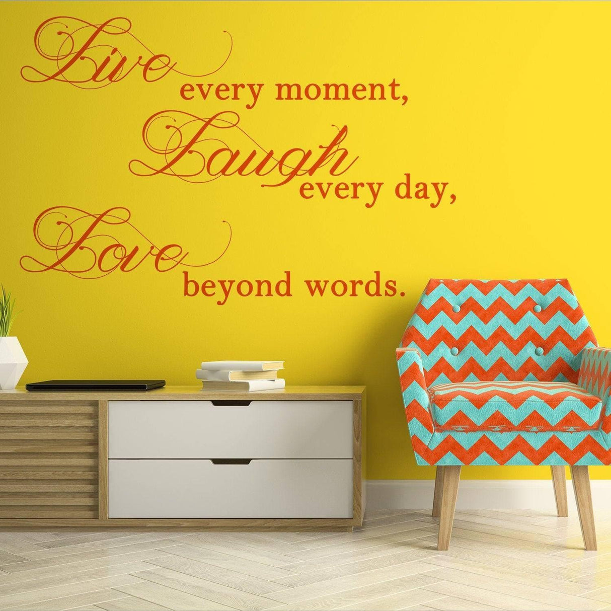 Live Laugh Love inspirational quote wall decal on yellow background with colorful chair and modern decor.