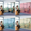 Woman using mirror privacy window film in office; showcasing blue and pink options for stylish privacy solutions.