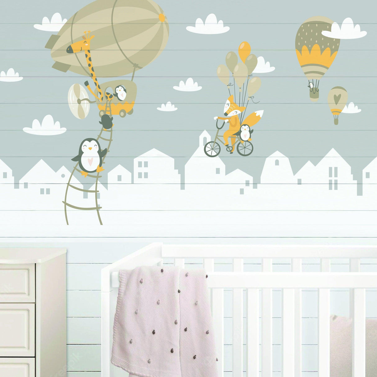 Adorable wall stickers featuring penguins and a fox with balloons, perfect for a child's nursery decor.