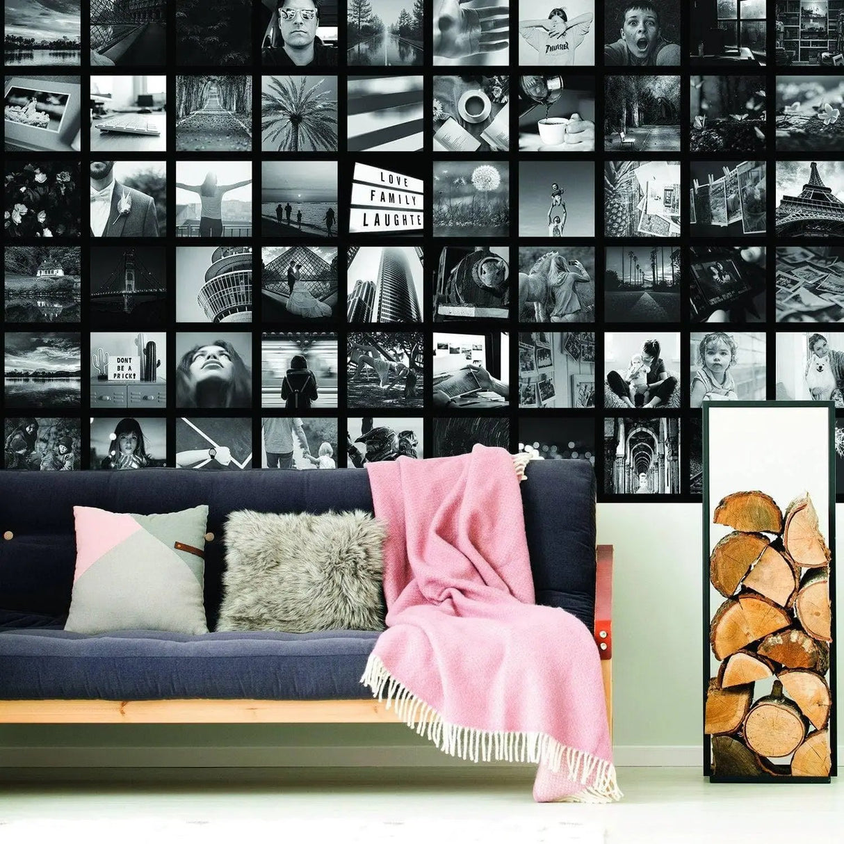Custom Memory Wall Art featuring black and white photo collage above a cozy sofa with a pink throw blanket.