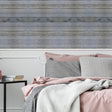 Rustic wood plank wall decal in a cozy bedroom, featuring shiplap peel and stick wallpaper.