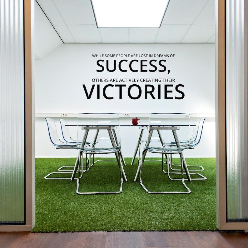 Inspirational wall decal in office, featuring quote about success and achieving dreams, motivational decor.