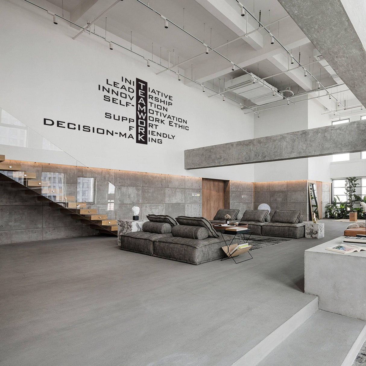 Modern office interior featuring a motivational wall decal emphasizing teamwork and collaboration.