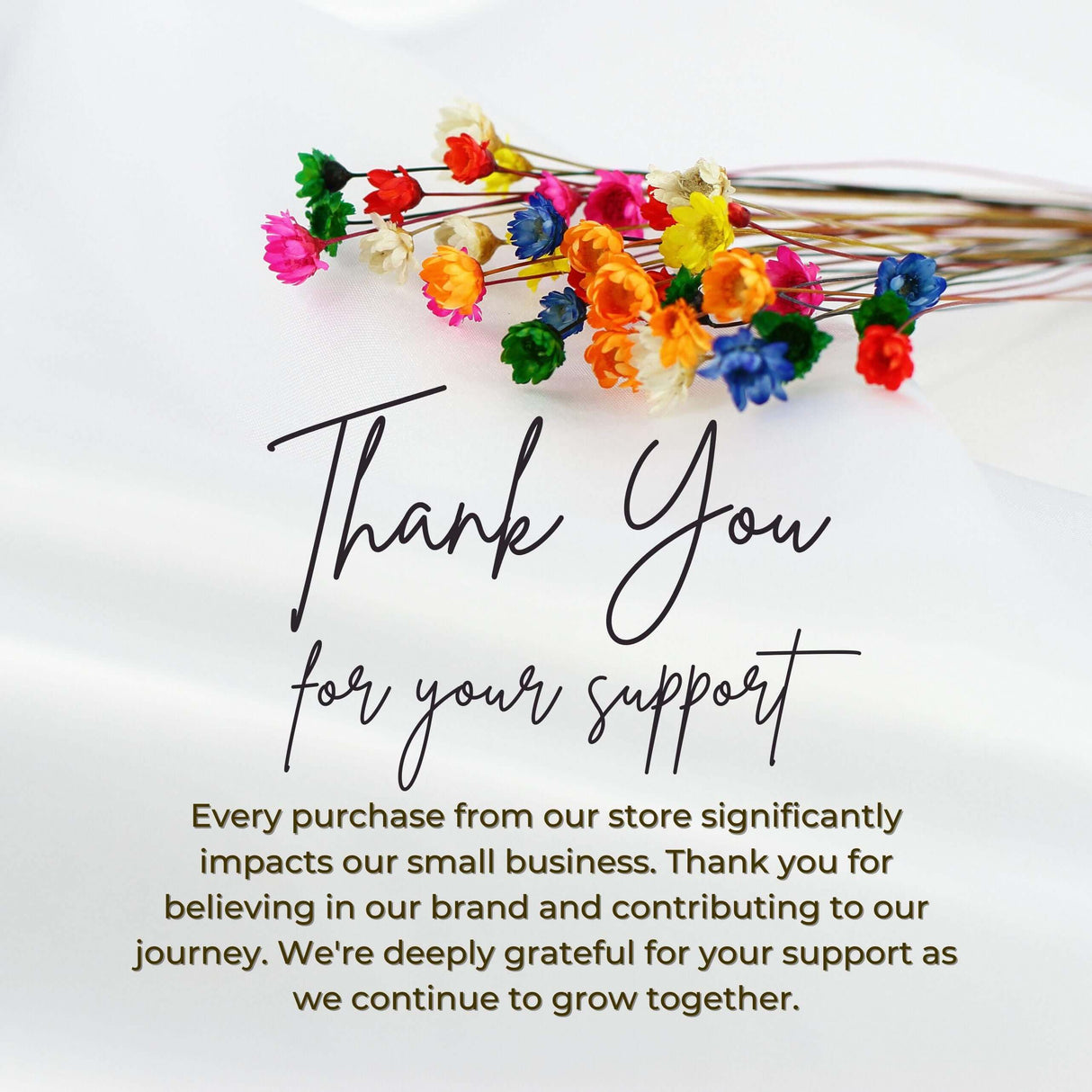 Colorful flowers with a thank you note expressing gratitude for supporting a small business.