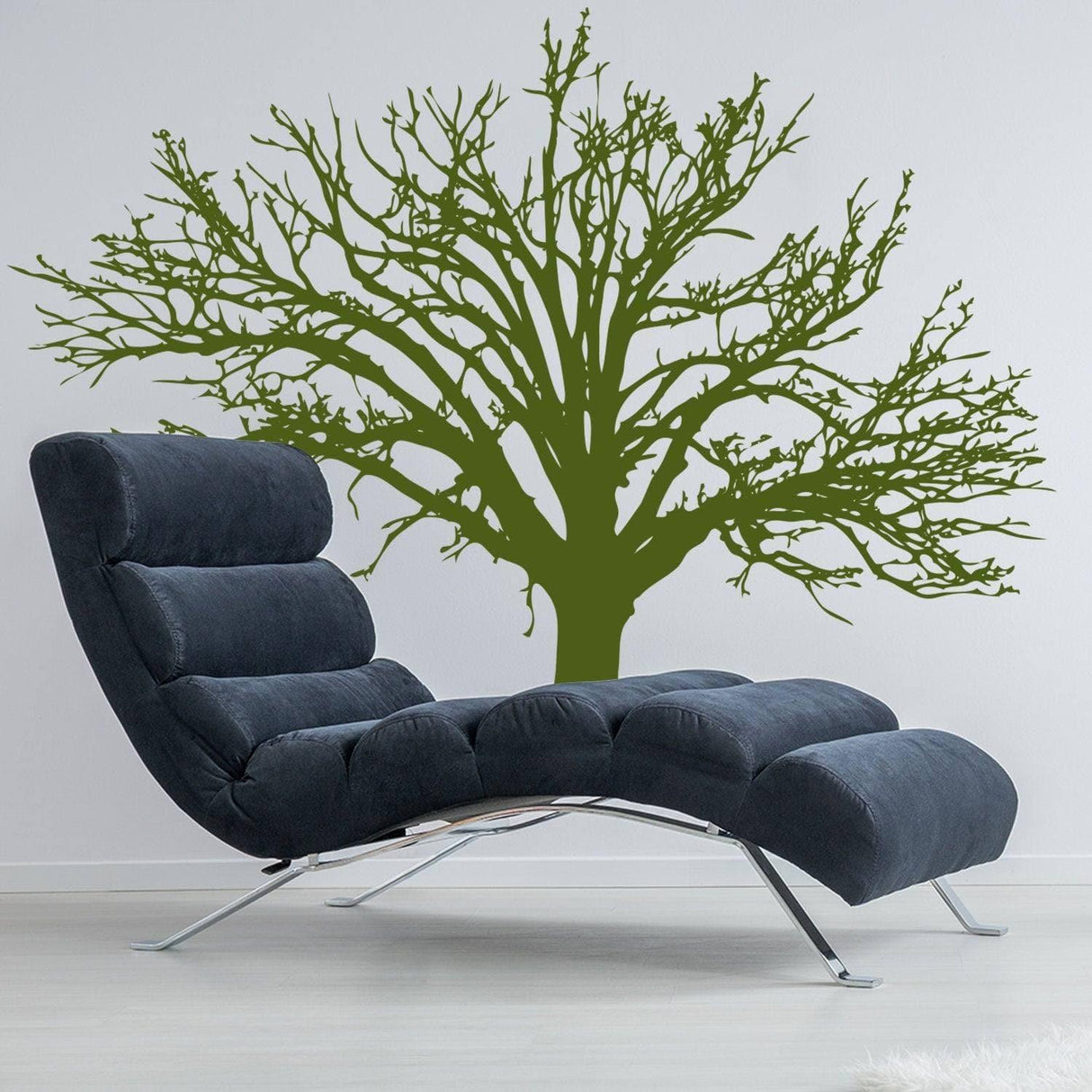 Stylish nature-inspired vinyl wall decal of a tree above a modern lounge chair, perfect for home decor.