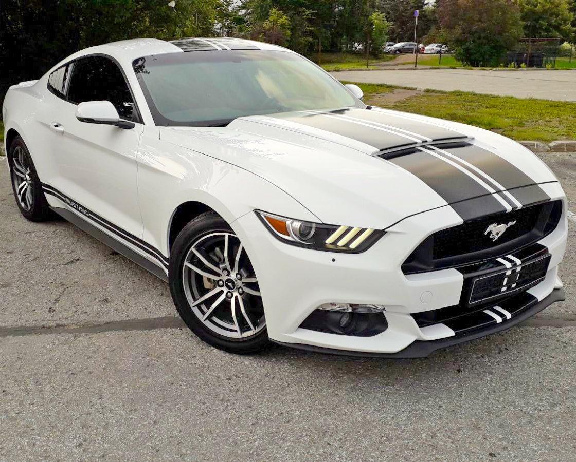 Stylish white car featuring bold black racing stripes for an enhanced sporty look.