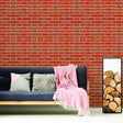 Cozy living room featuring a brick wall, soft pillows, and a pink throw blanket. Perfect for home makeover inspiration.