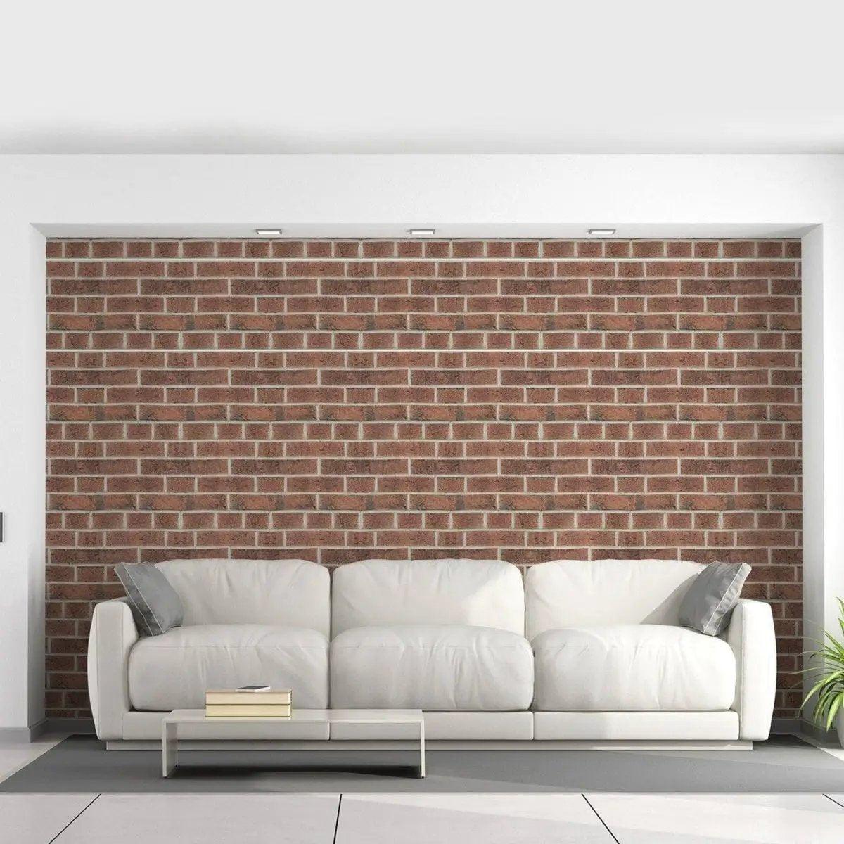 Stylish living room featuring 3D brick self-adhesive wallpaper behind a white sofa with cushions.