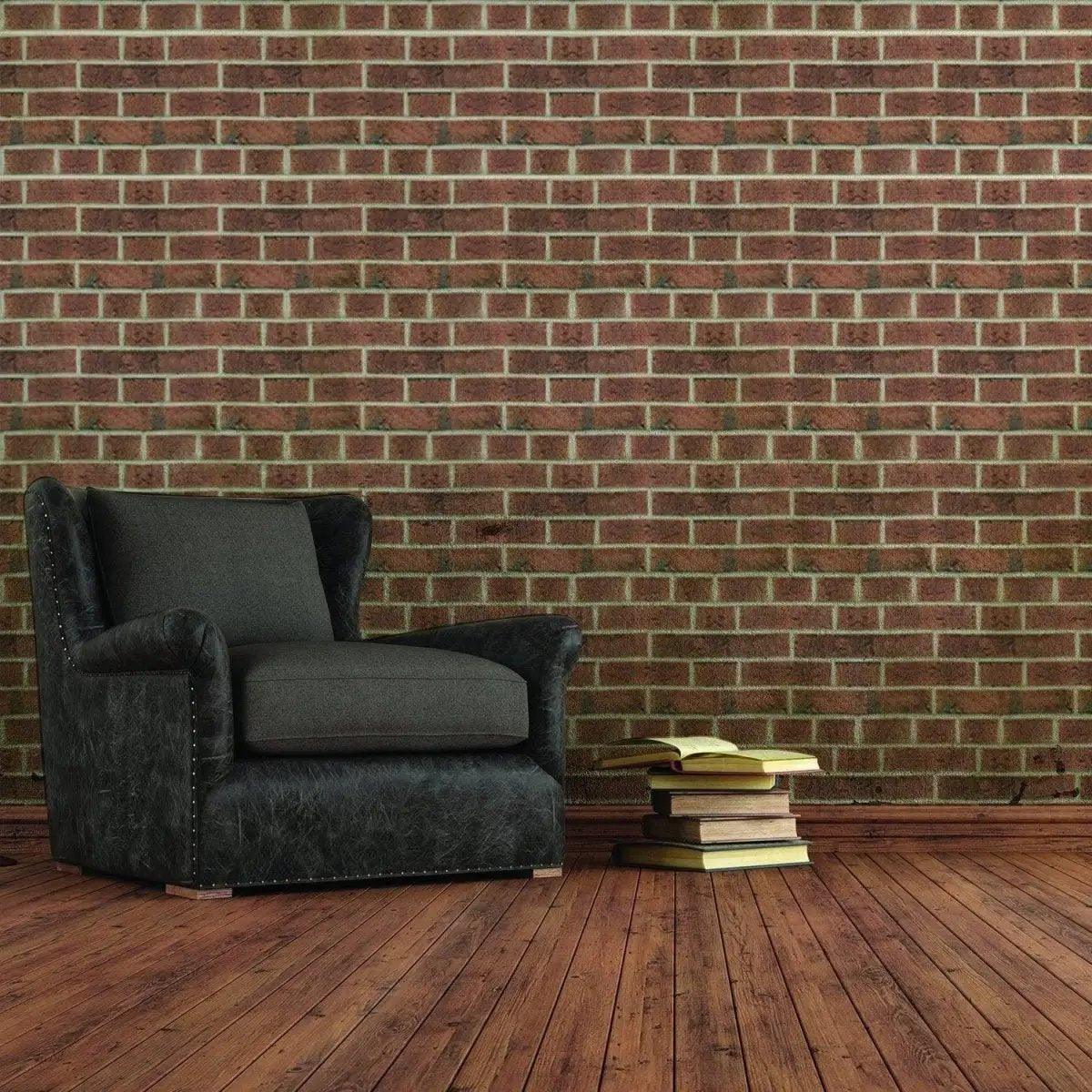 Living room featuring 3D stone wall vinyl wallpaper with a black chair and stacked books on wooden floor.