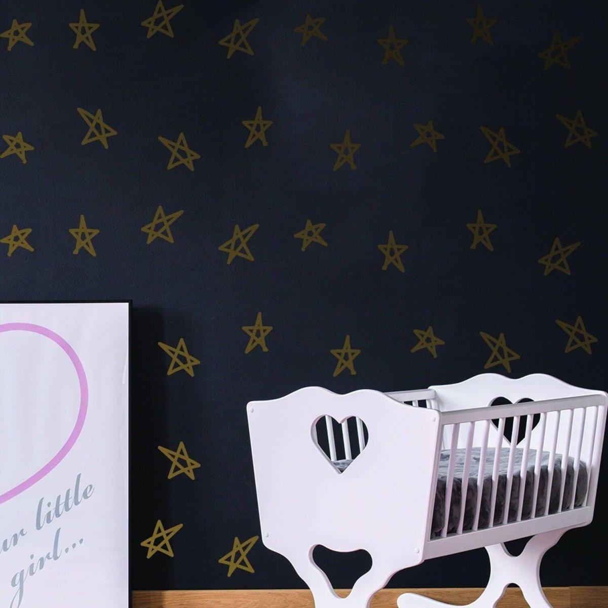 Magical star stickers on nursery wall with crib and decorative poster, perfect for baby shower decor.