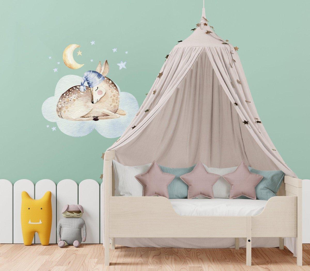 Cloud animal wall decal in a nursery above a cozy bed with pink stars and playful decor elements.