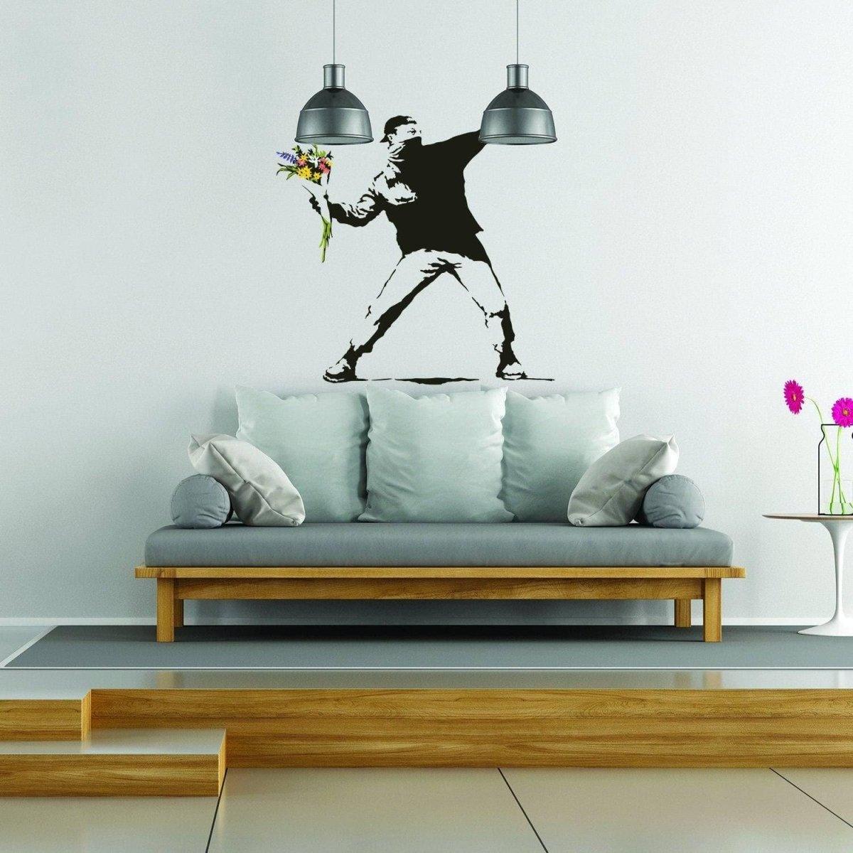 Banksy flower throw wall decal on living room wall, adding artistic flair to home decor.