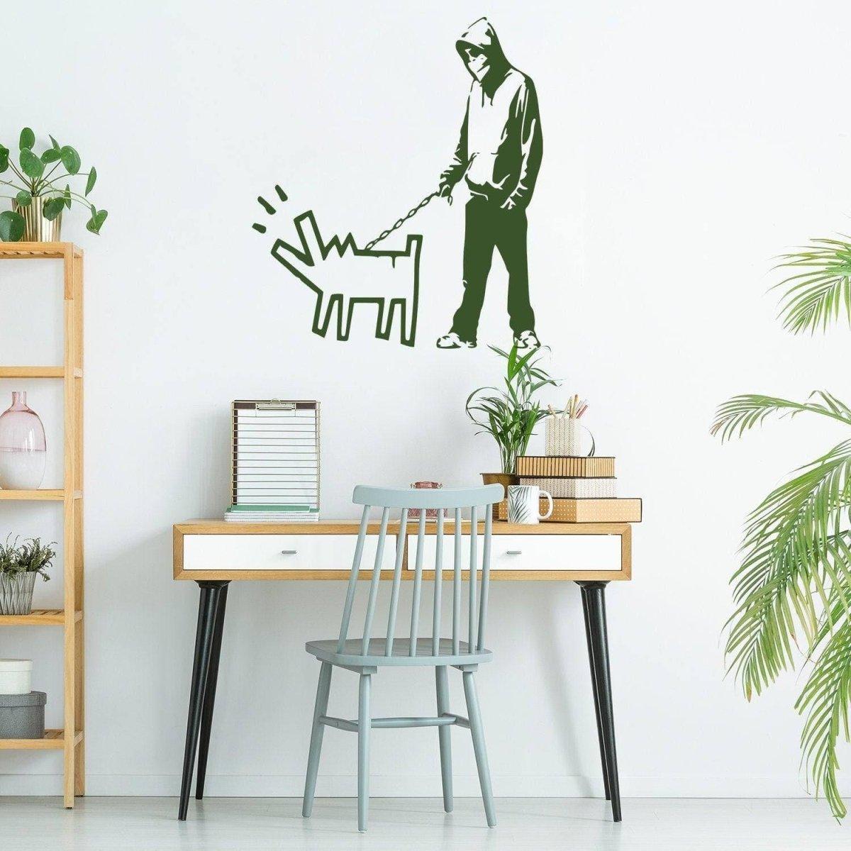 Banksy wall art decal of a person walking a dog on a wall in a stylish office setting.