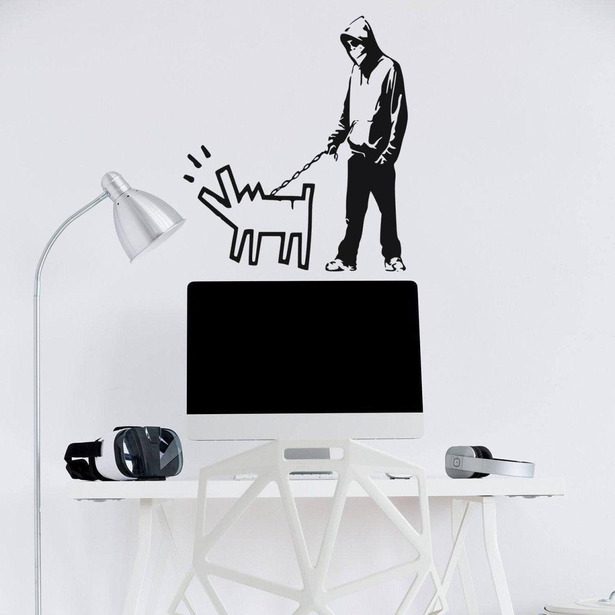 Banksy wall art decal featuring a hooded figure walking a dog, ideal for any stylish workspace.