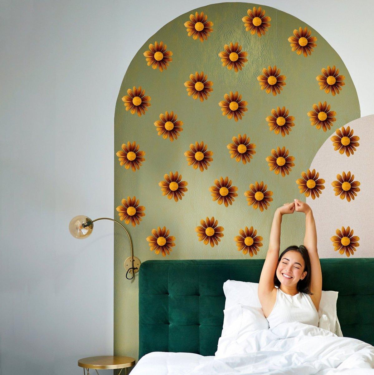 A woman enjoying her cozy bedroom with Boho Blossom Daisy wall stickers, featuring vibrant brown flower decals.