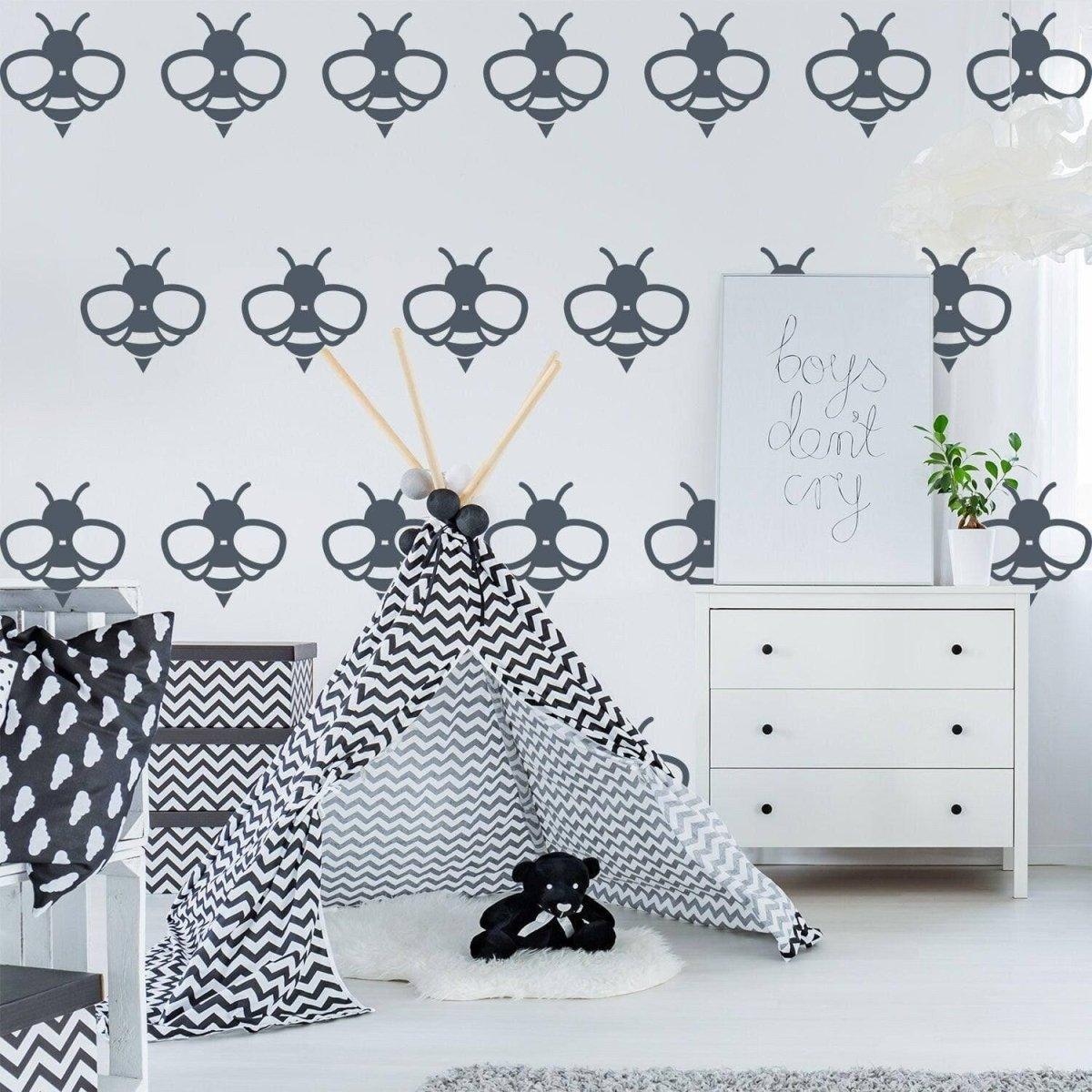Bumblebee wall decals in a modern nursery with a grey and white theme, featuring a teepee and playful decorations.