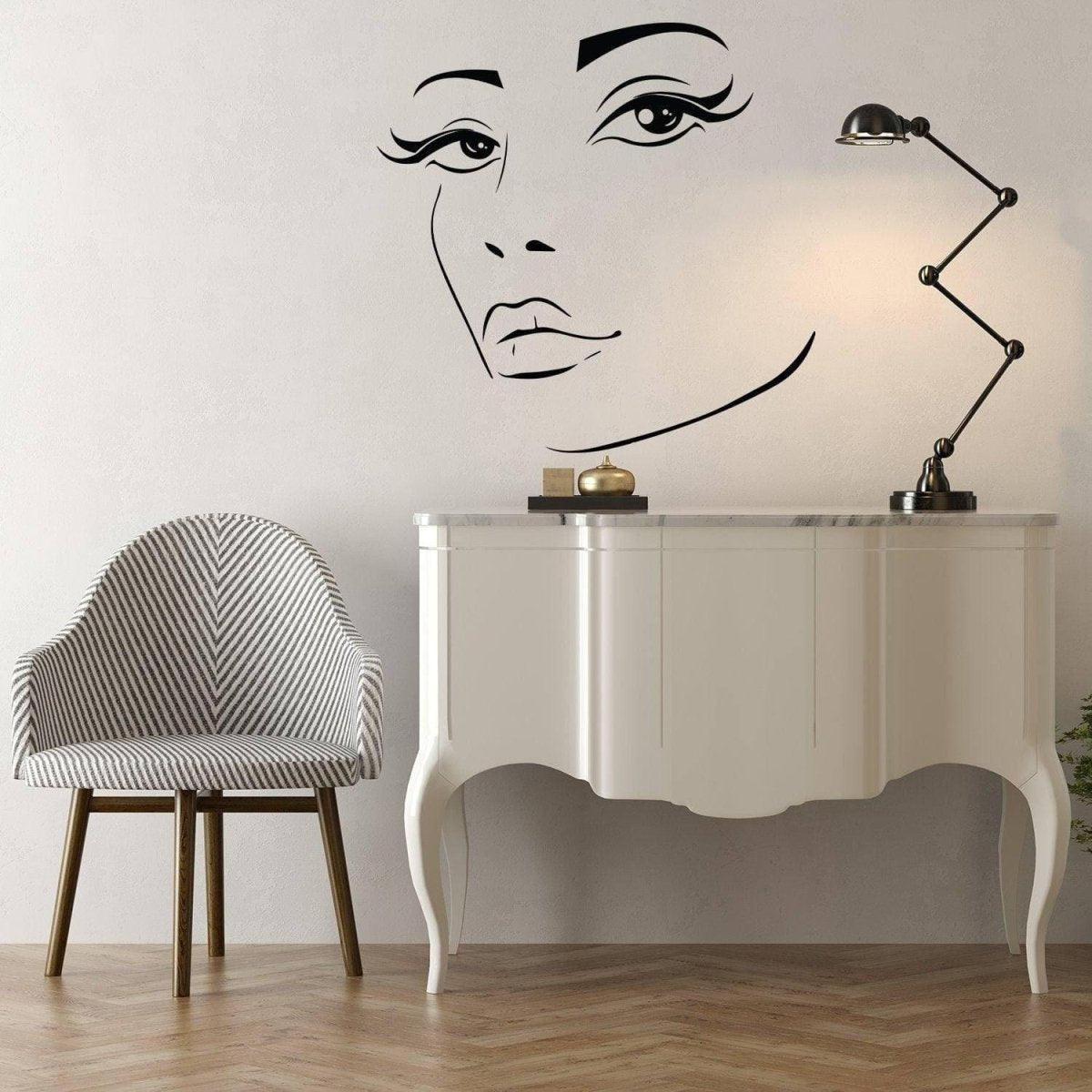 Charming Woman Face Vinyl Wall Decal above a stylish white console and modern chair, enhancing interior design.