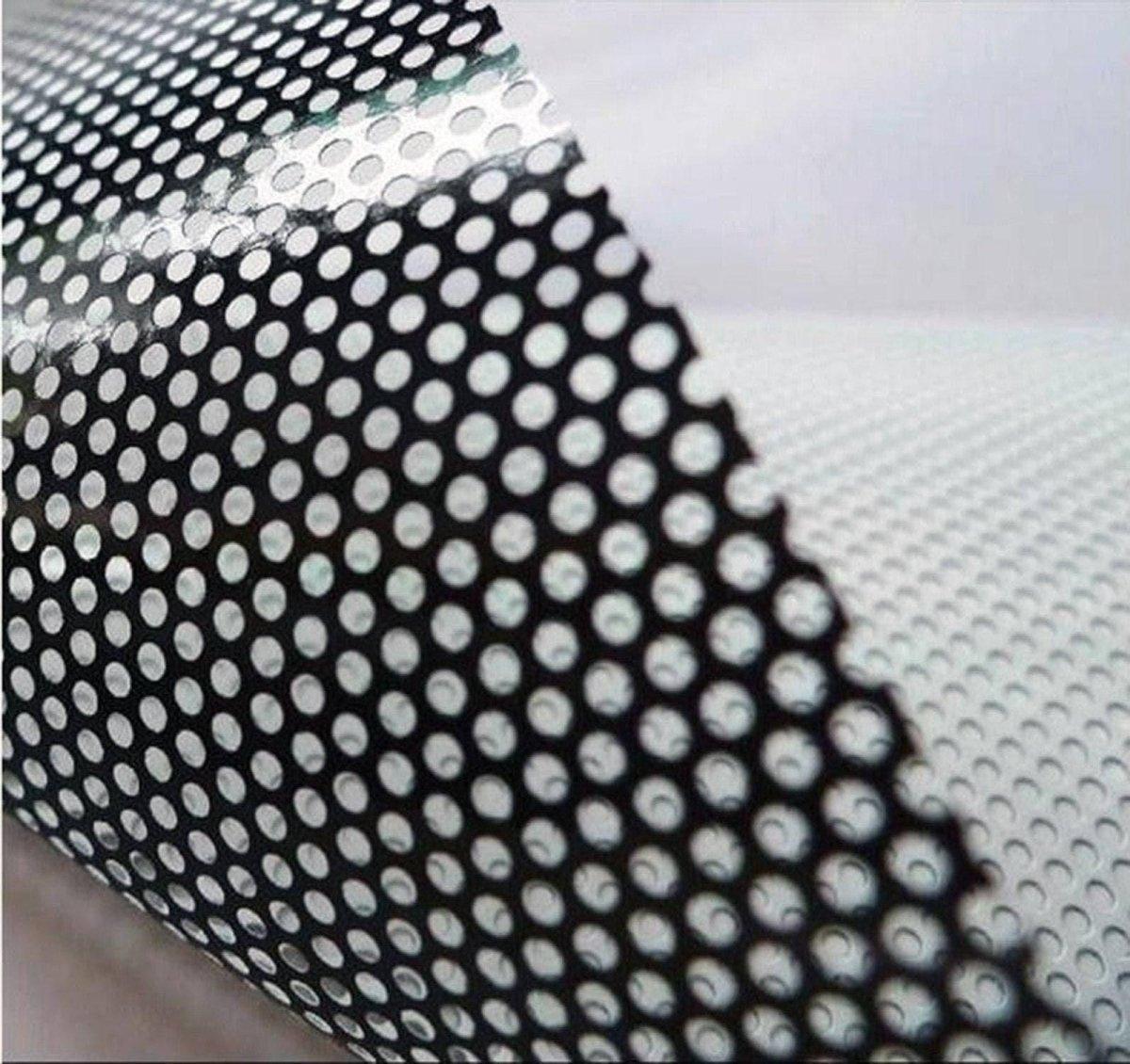 Close-up of perforated vinyl film for car decals, showcasing black and white dot pattern.