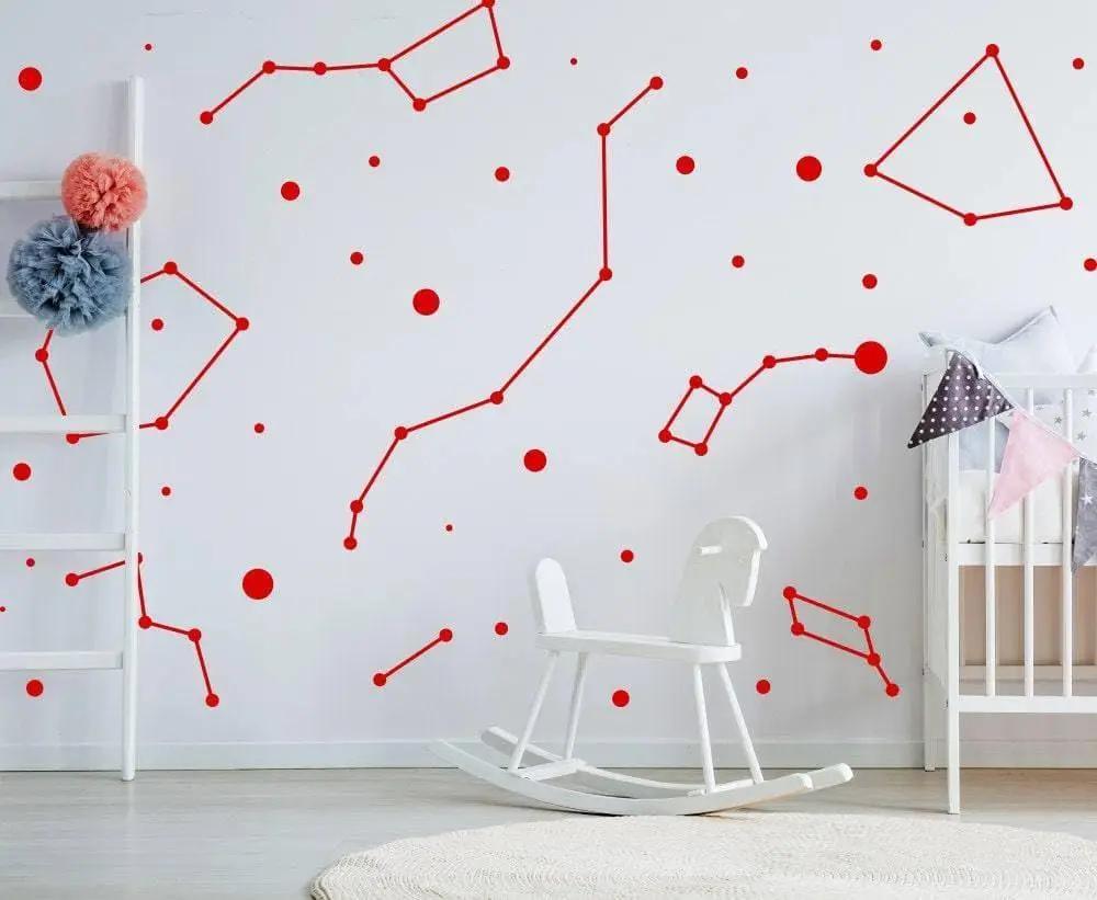 Red constellation wall stickers on a white nursery wall, creating a celestial decor atmosphere.