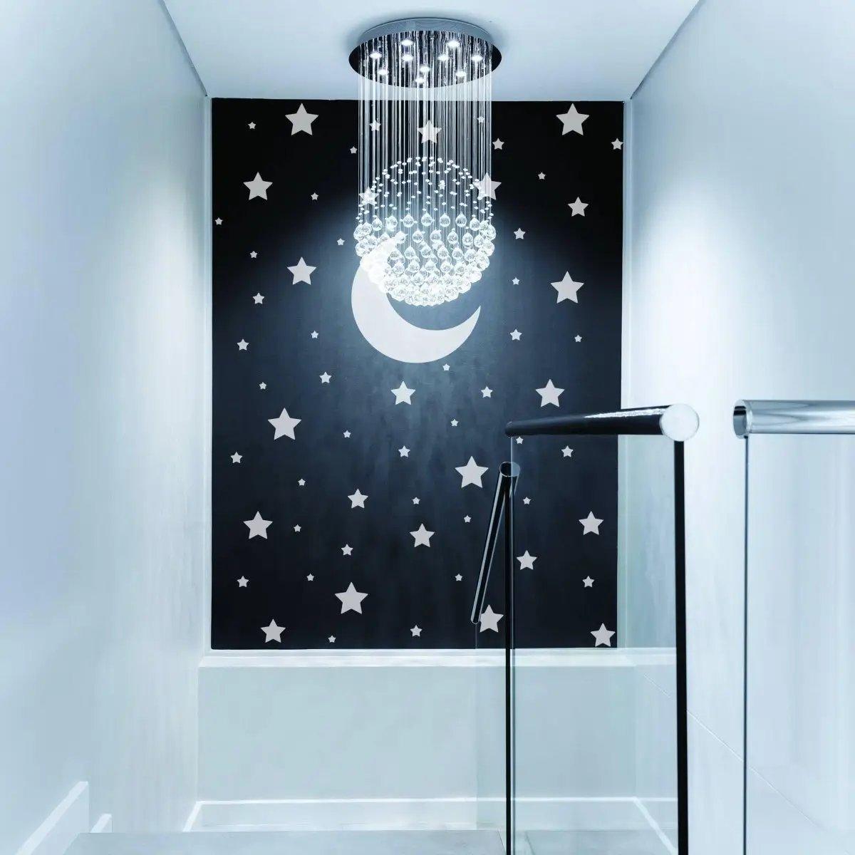 Celestial wall decals featuring white stars and moon in a modern room with stylish chandelier lighting.