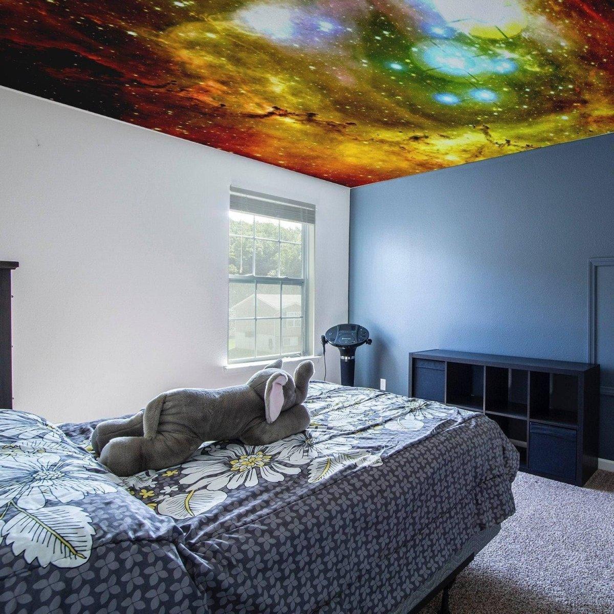 Celestial vinyl ceiling decal transforming a bedroom into a galaxy-themed oasis with colorful cosmic design.