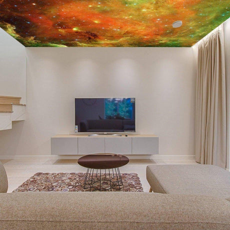Cosmic galaxy vinyl ceiling decal in a modern living room with TV and cozy furniture.