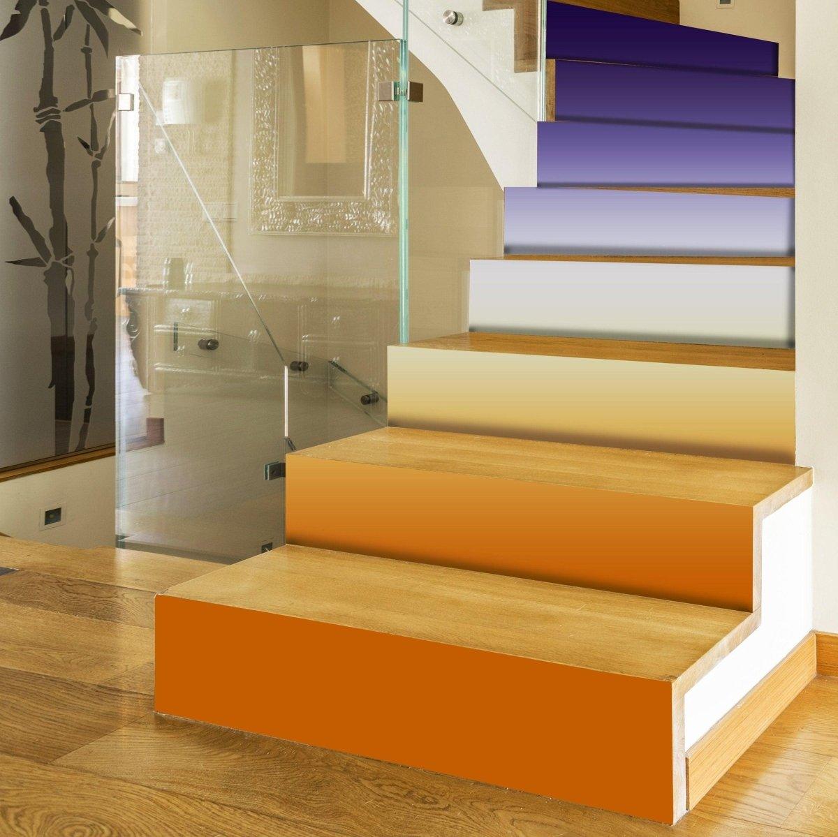 Vibrant staircase with gradient color riser stickers, showcasing a transformation from plain to colorful.