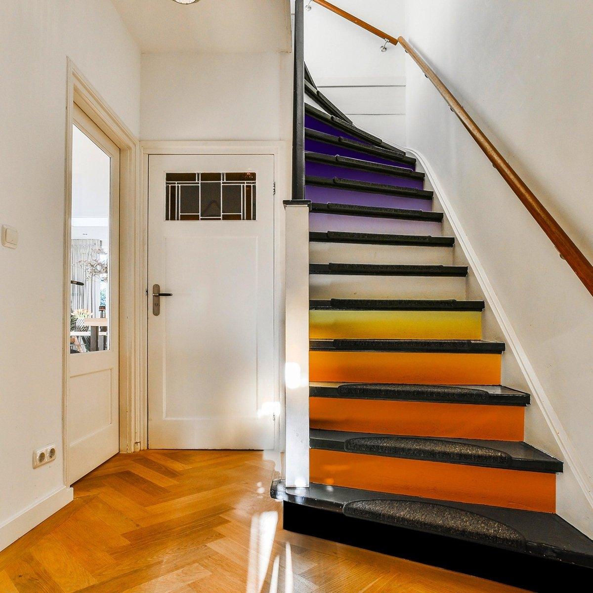 Colorful staircase with gradient riser stickers in purple and orange, enhancing home decor with a vibrant transformation.