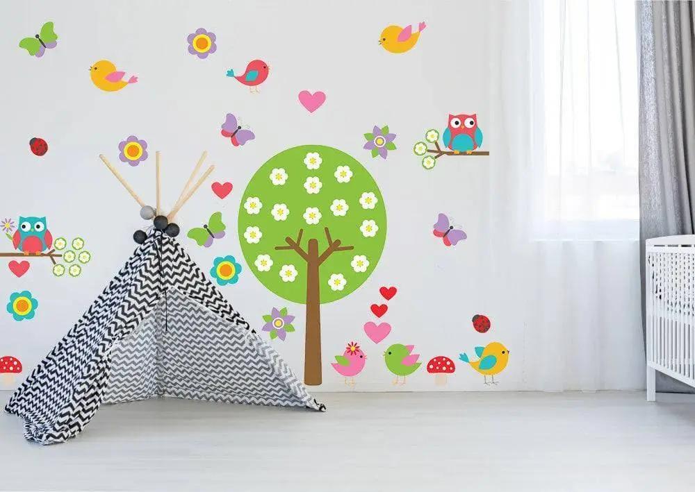 Vibrant tree wall sticker with colorful birds and flowers in a nursery, enhancing playful decor with whimsy design.