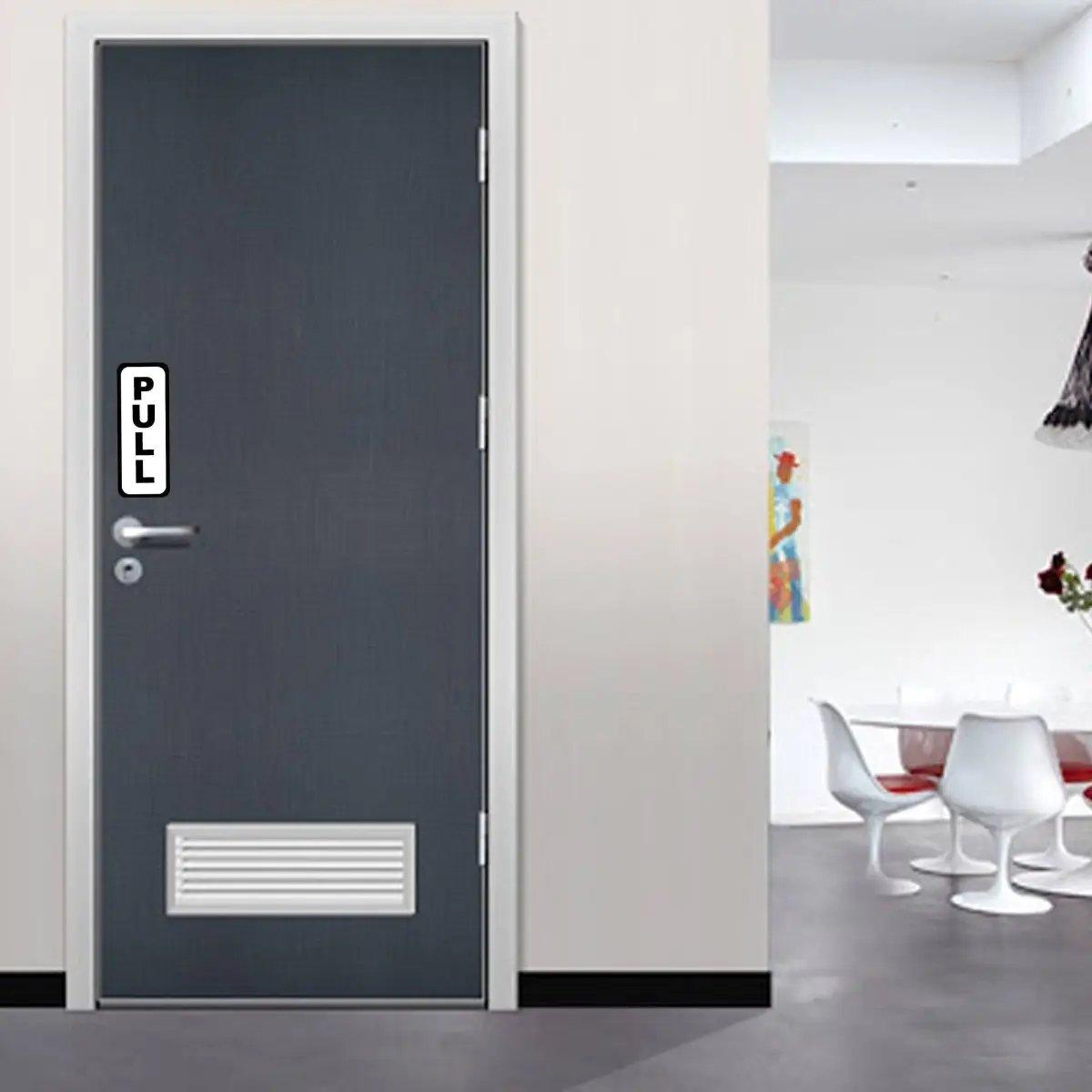 Door with 'PULL' sticker for clear guidance in commercial spaces, enhancing accessibility for guests and employees.