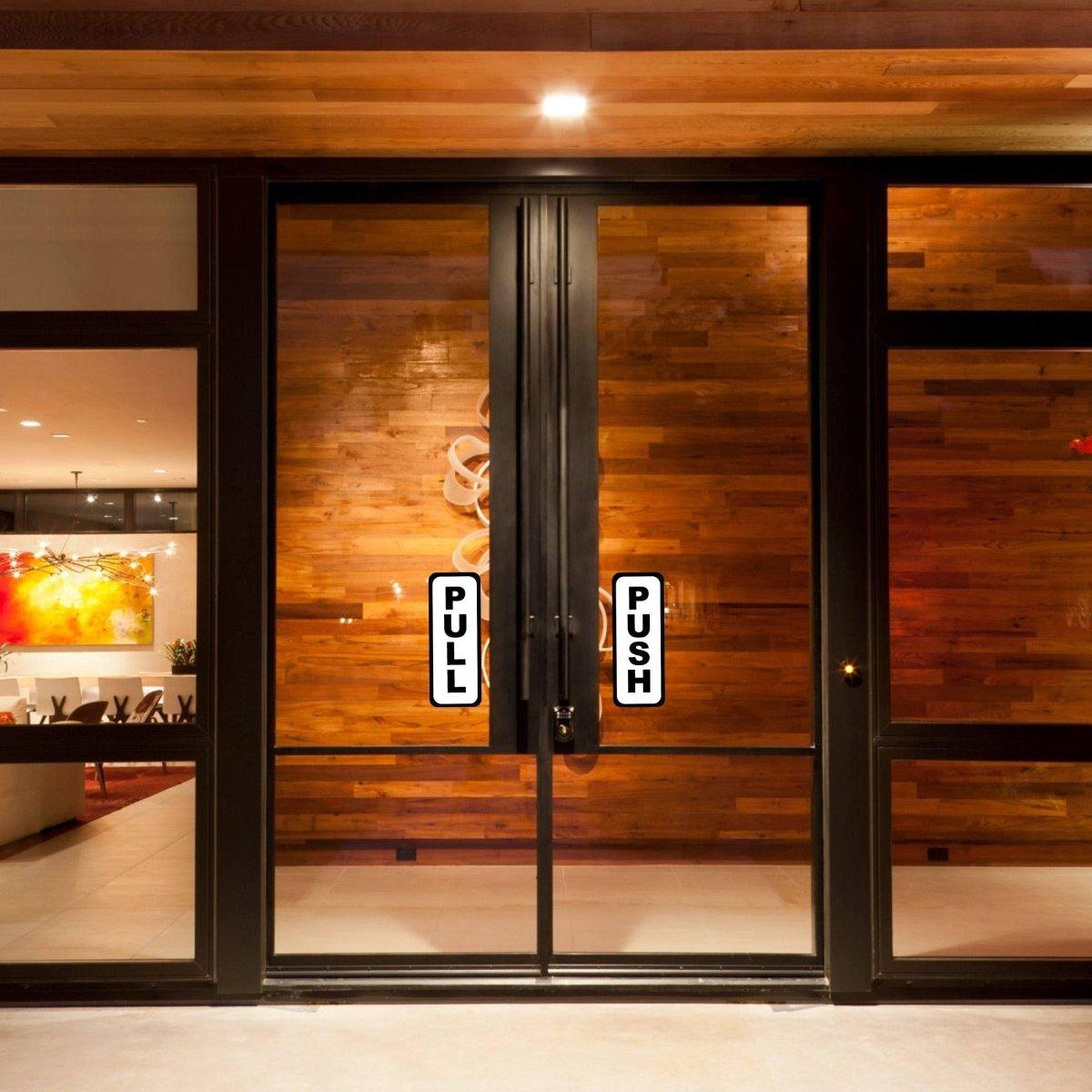 Double glass doors with "PULL" and "PUSH" vinyl stickers for easy entry guidance in commercial spaces.
